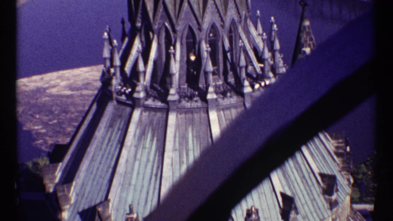 Gothic spires and copper roof seen from above with a dark beam crossing the foreground.