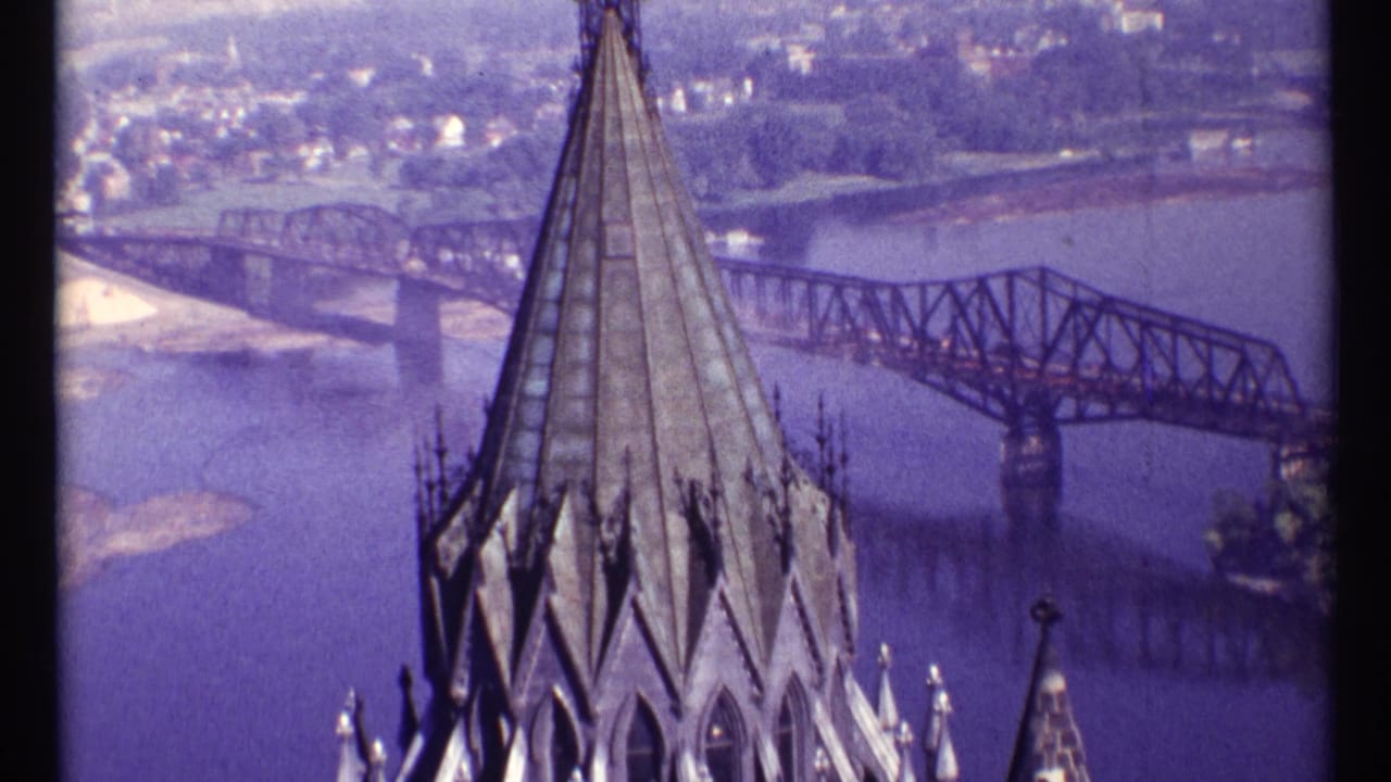 Ottawa, 1967, with the spire centered against Alexandra Bridge and a hazy riverside background.