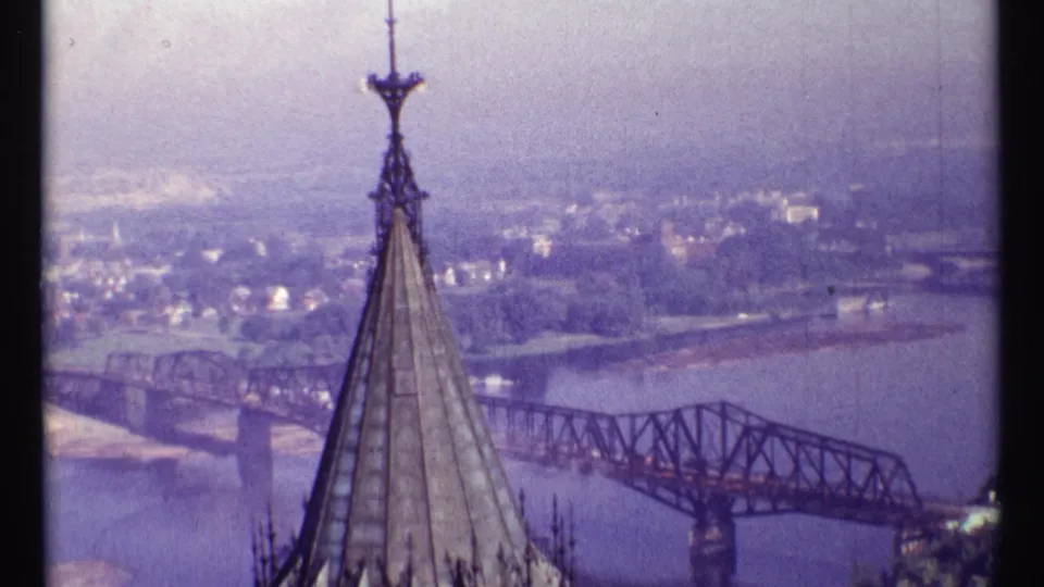 Final 1967 Ottawa frame with the spire in the foreground and Alexandra Bridge crossing the river behind it.