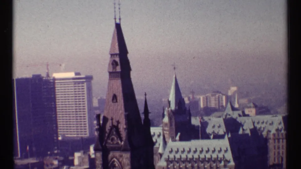 Ottawa skyline from a visitor vantage point, with a prominent Gothic spire and modern buildings visible through 8mm haze.