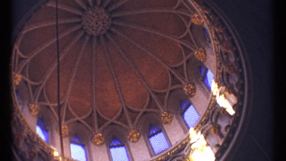 1967 Ottawa home-movie frame holding on the ornate dome interior, with blue arched windows and gold details along the circular wall.
