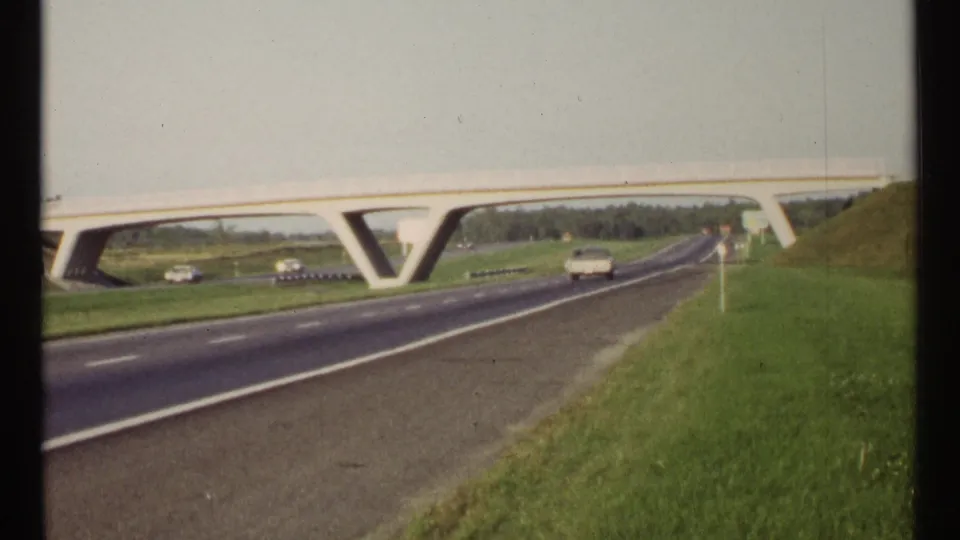 1967 Ottawa road view showing a V-supported concrete overpass, several cars, open grass, and a sloped embankment.