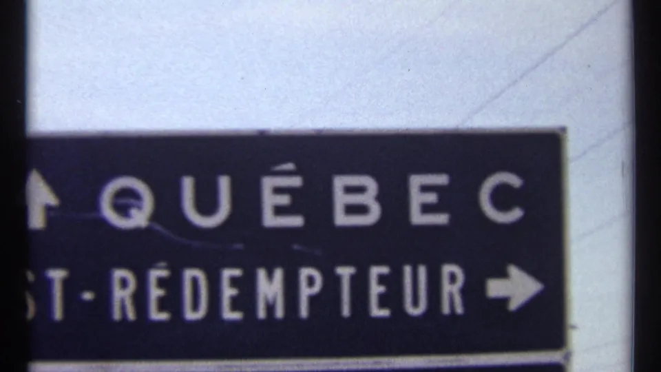 1967 Ottawa-area frame with a dark road sign, white Québec lettering, partial St-Rédempteur text, and directional arrows.