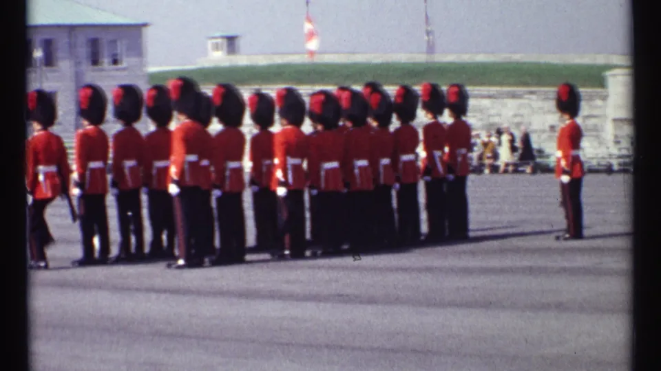 1967 Ottawa home-movie frame showing a close view of the ceremonial guard formation on a stone-walled parade ground.