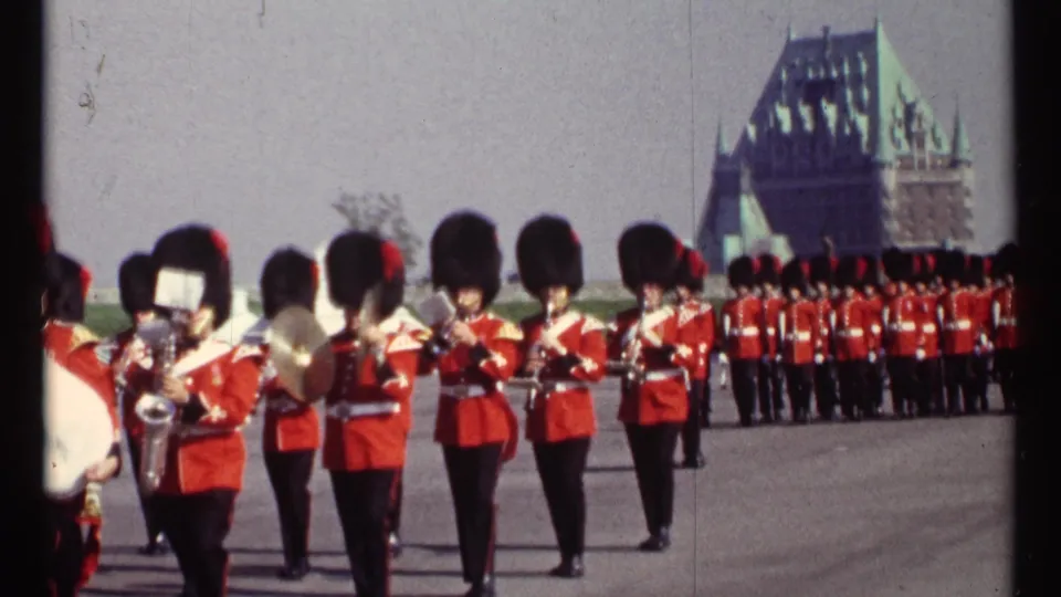 1967 Ottawa home-movie close view of uniformed band musicians playing brass while marching in formation.
