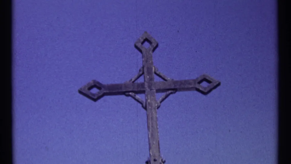1967 Ottawa 8mm frame showing the weathered cross from a slightly lower, close visitor-shot angle.