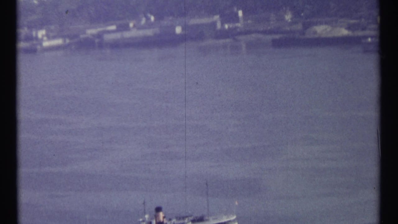 Distant water view with shoreline and a large vessel near the top of the frame.