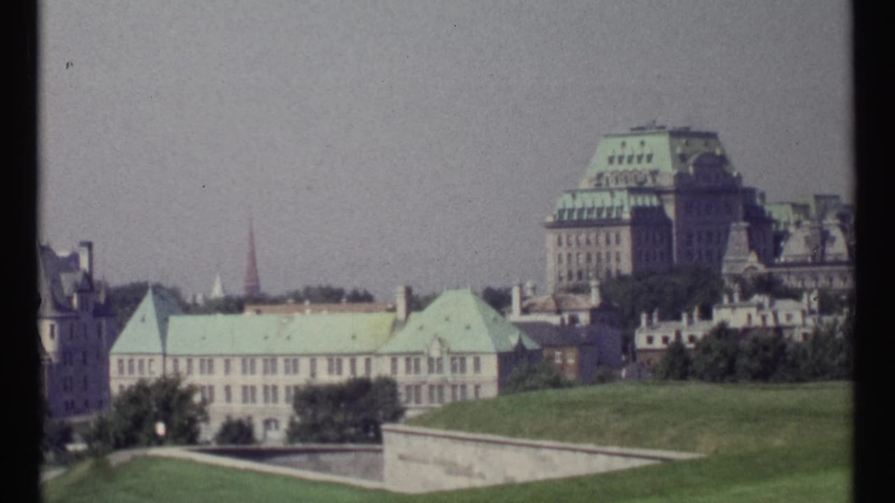 Ottawa stone buildings with green copper roofs above lawns and terraces.