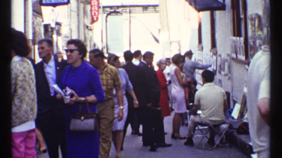 Ottawa 1967 street-level shopping scene with adults in 1960s clothing moving past storefronts, chairs, and display racks.