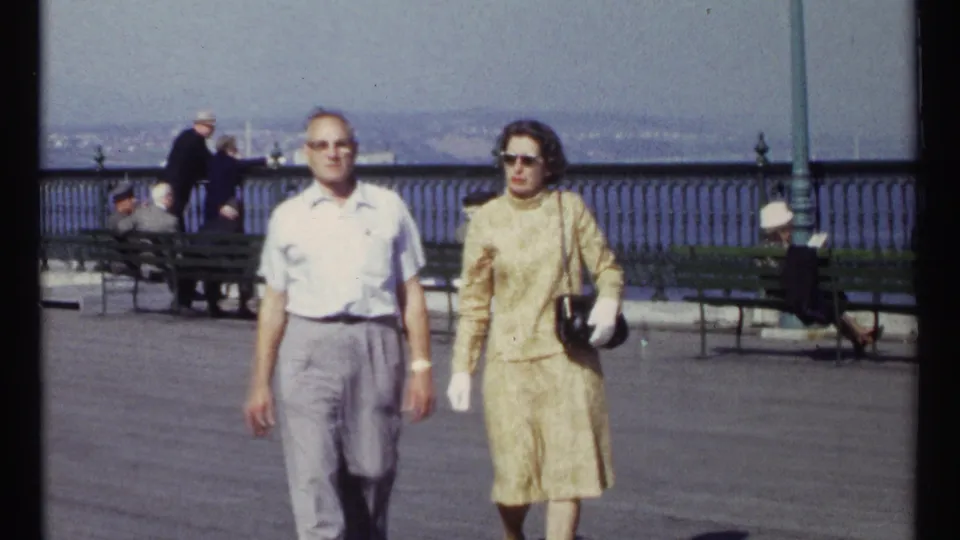 The final 1967 Ottawa frame shows the couple nearest the camera, with public benches, a decorative railing, and waterfront background still visible.
