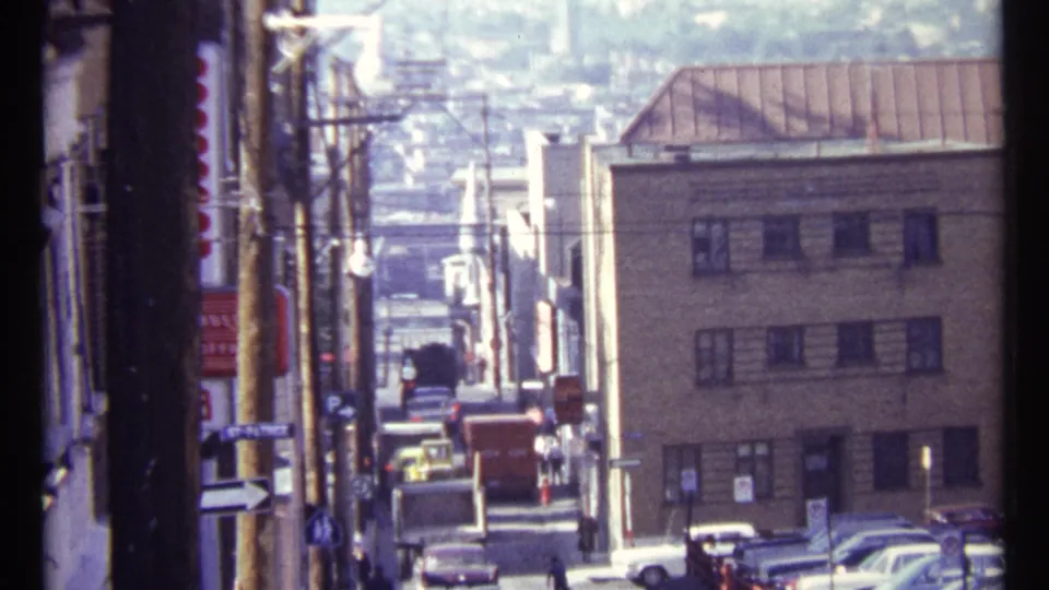 1967 Ottawa street view with mid-century cars moving between closely spaced buildings and utility poles.