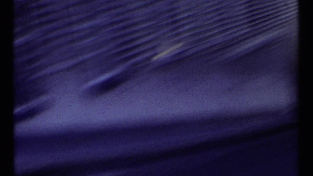Blurred dark film area beside a distant bridge frame edge.