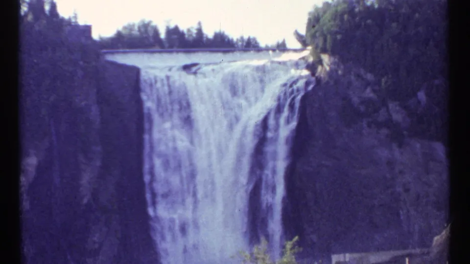 1967 Ottawa home-movie frame with a closer view of white water descending between dark rock faces.