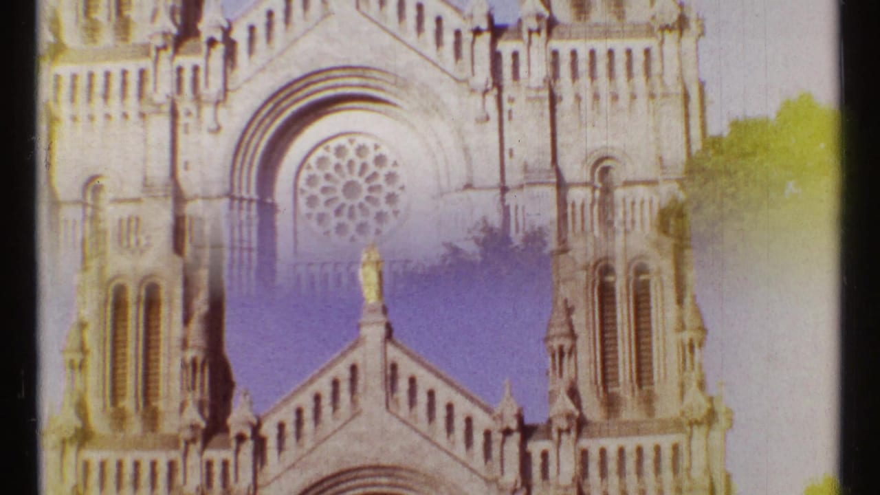 Upper cathedral facade with rose window, roofline, and central statue.