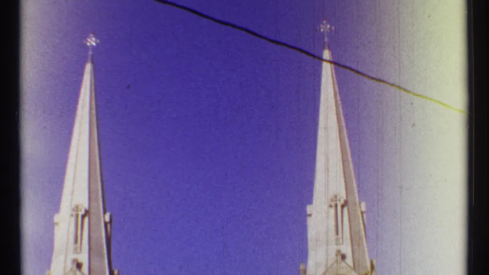 1967 Ottawa 8mm frame isolating pointed church spires, cross finials, sky, and visible film-edge exposure.