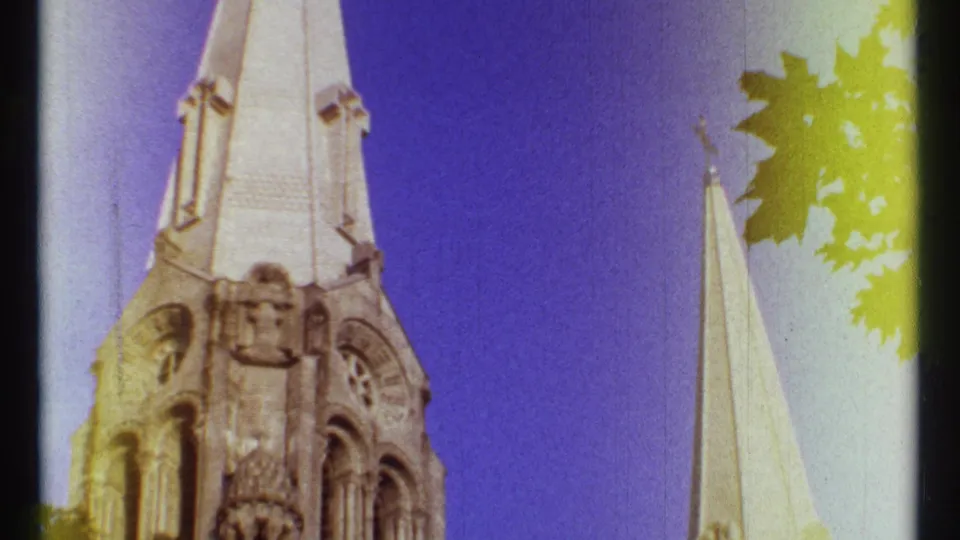 Low-angle Ottawa cathedral view with a tower, narrow spire, blue sky, leaves, and strong yellow-purple 8mm color shifts.