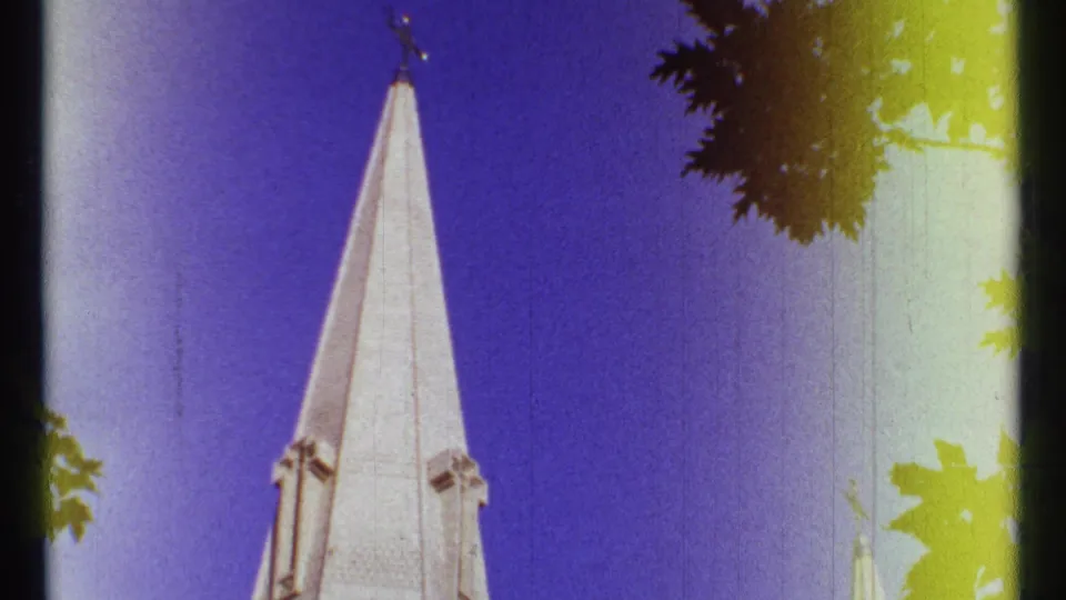 Ottawa 1967 frame with the church steeple centered, a smaller spire to the right, foliage above, and 8mm color shift.