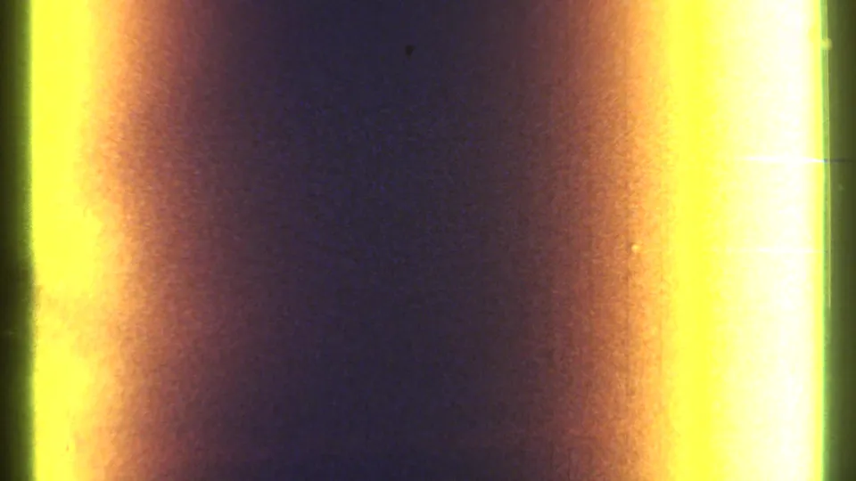8mm home-movie frame showing heavy yellow-orange light leaks and dark vertical banding rather than a clear subject.