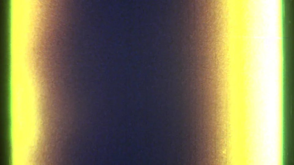 1967 Ottawa 8mm frame dominated by yellow-green exposure streaks, a central dark divider, and coarse blue film grain.