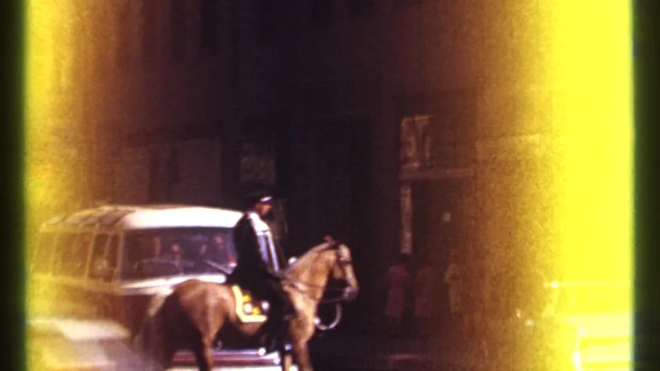 Nighttime Ottawa street footage shows a mounted police officer on horseback near a vintage van and cars under dim city lighting.