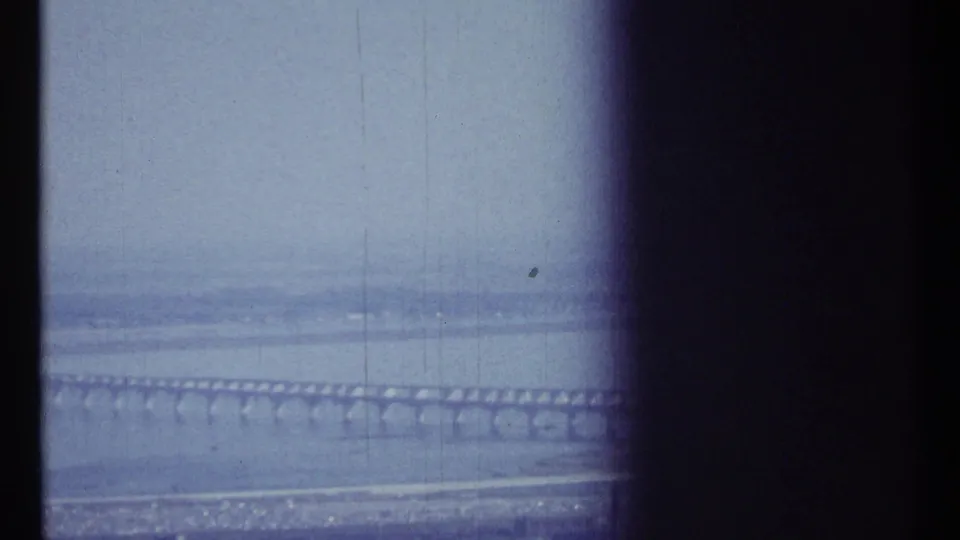 Ottawa-area river bridge in a 1967 home-movie frame, with water below and dark film edge obscuring the right side.