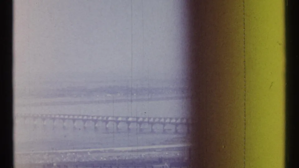 Ottawa, Canada bridge scene from 1967 8mm footage, with the span faintly visible through haze and film wear.