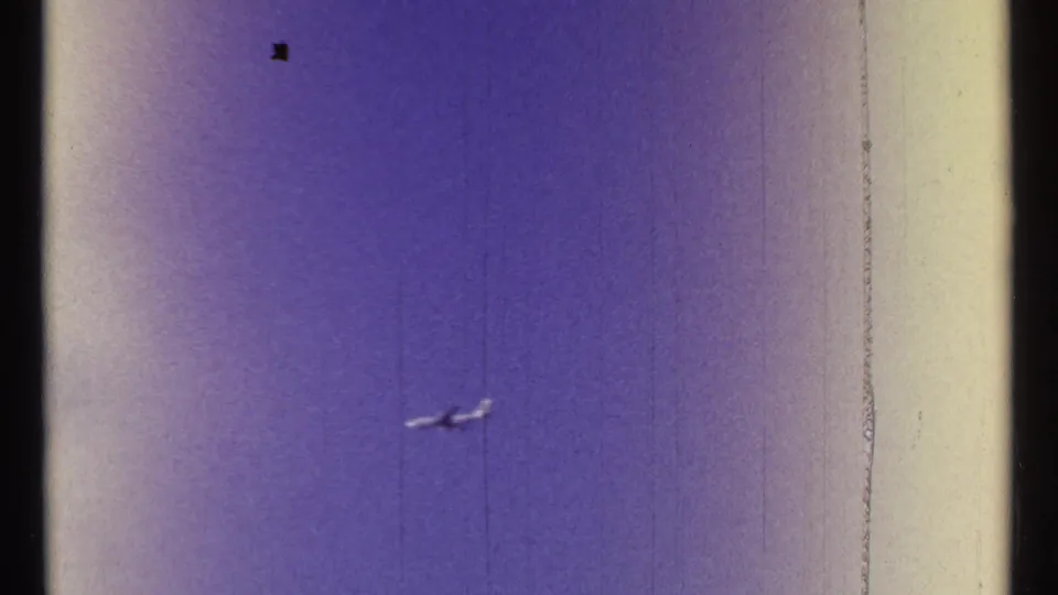 A small airplane appears against a clear blue sky in the 1967 Ottawa clip, with visible grain, color fading, and film edge marks.