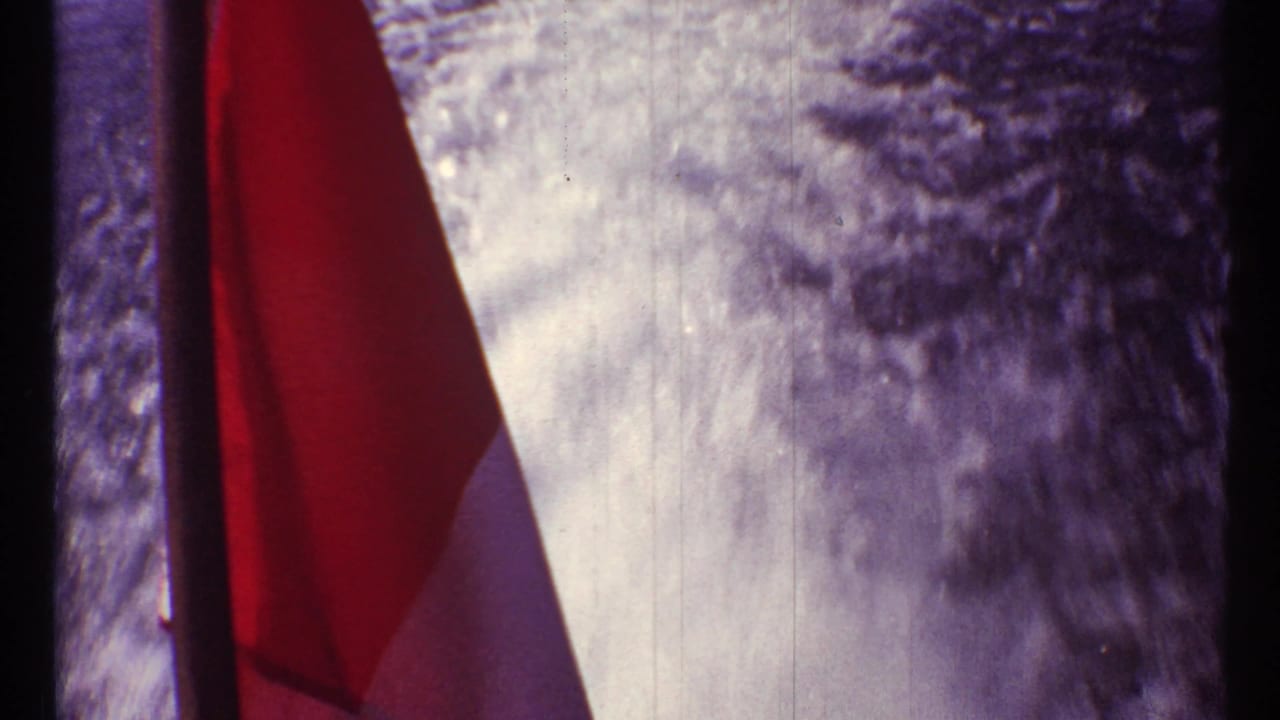 Canadian flag beside a textured pale background with dark vertical film edge.