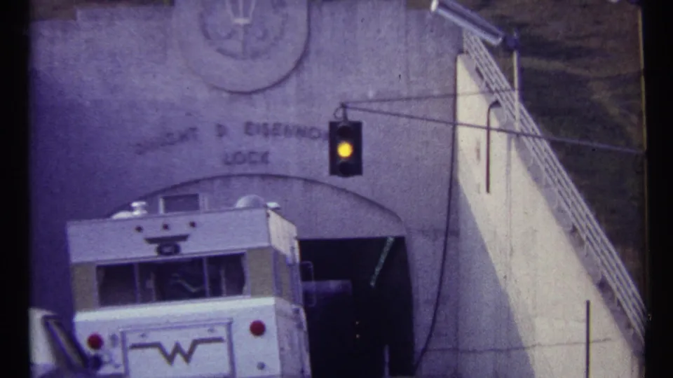 1967 8mm frame showing the rear of a white truck at the Dwight D. Eisenhower Lock entrance.