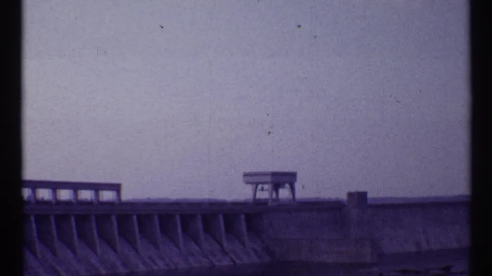 1967 Toronto frame showing the dam continuing across the lower frame, with one small platform structure on top.