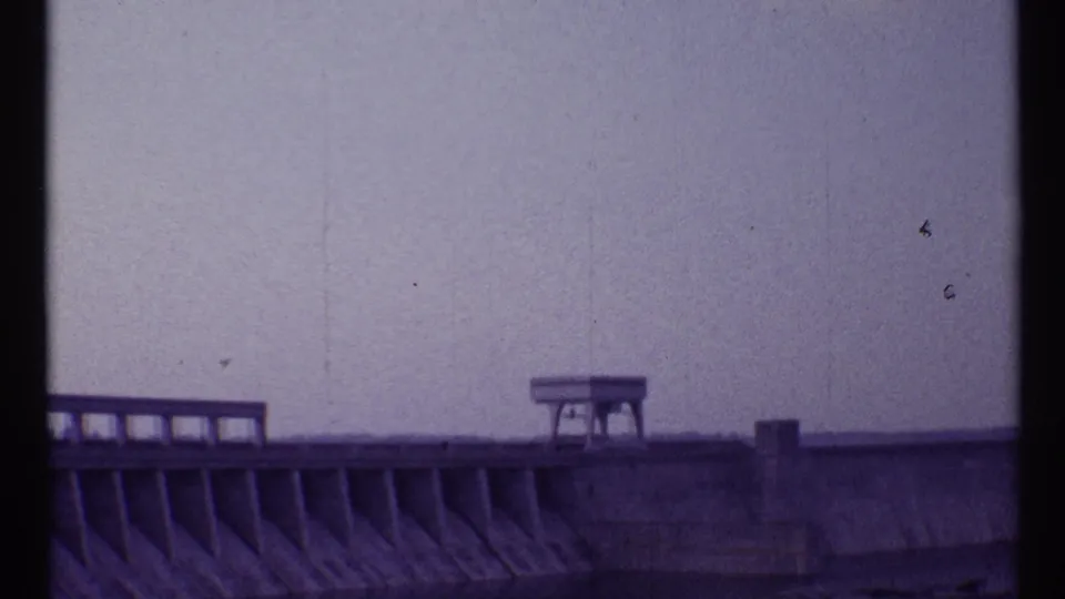 1967 Toronto 8mm frame showing a concrete bleacher or dam-like structure with railings and a small elevated platform.