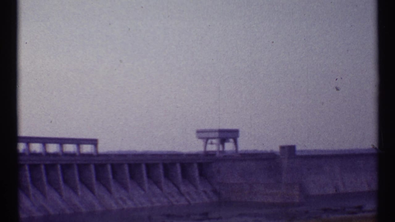 Concrete tiers with railing and small platform against sky.