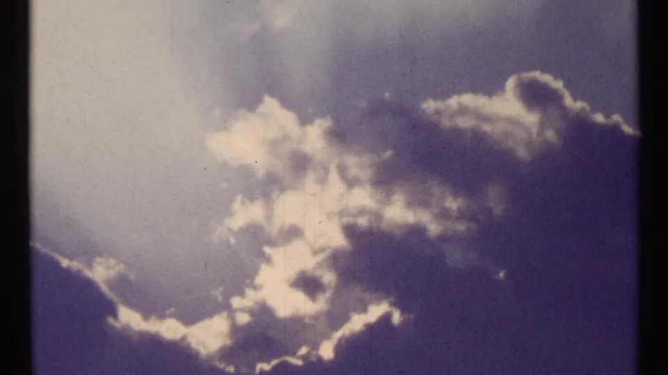 1967 Toronto 8mm cutaway to bright clouds and darker cloud edges in an open sky.