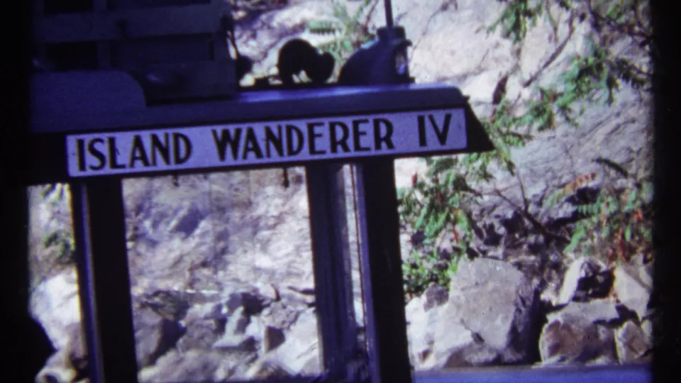 The Island Wanderer IV nameplate appears on the vessel, with rocks, foliage, and a dark boat structure visible in the 1967 Toronto footage.