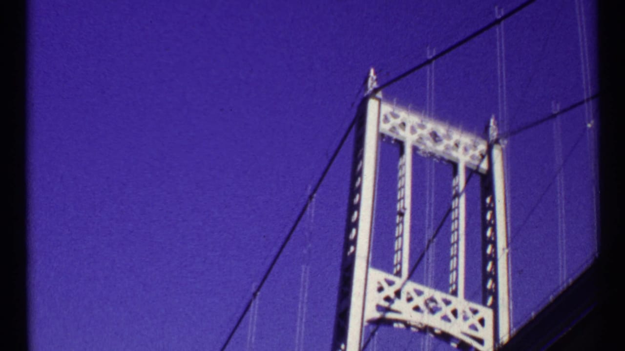 1967 Toronto 8mm frame with the bridge tower shifted right, showing cables, latticework, and dark foreground structure.