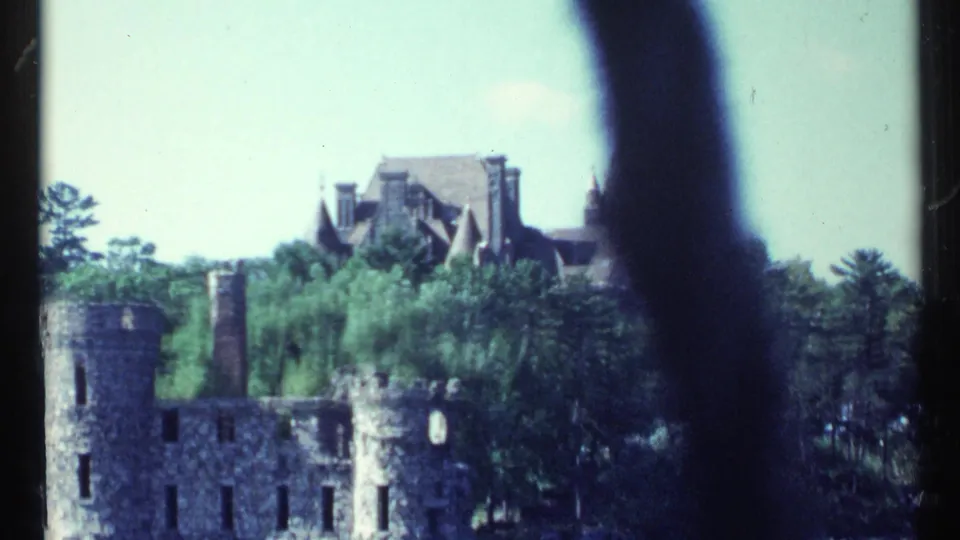 A closer boat-level view shows waterfront stone ruins, trees, and the upper stories of a castle-like mansion in Toronto, Canada, in 1967.