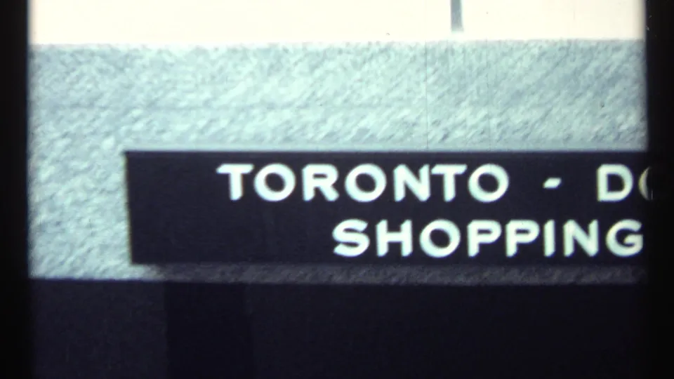 1967 Toronto home-movie title card with partial white lettering, including “TORONTO - D” and “SHOPPING.”