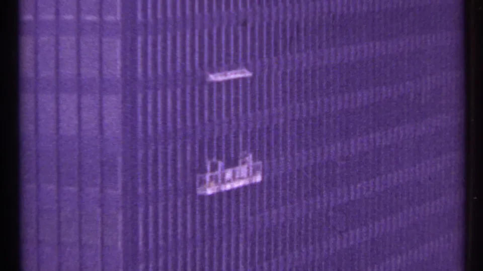 Two window-washing platforms hang against a tall Toronto building facade in the 1967 footage.