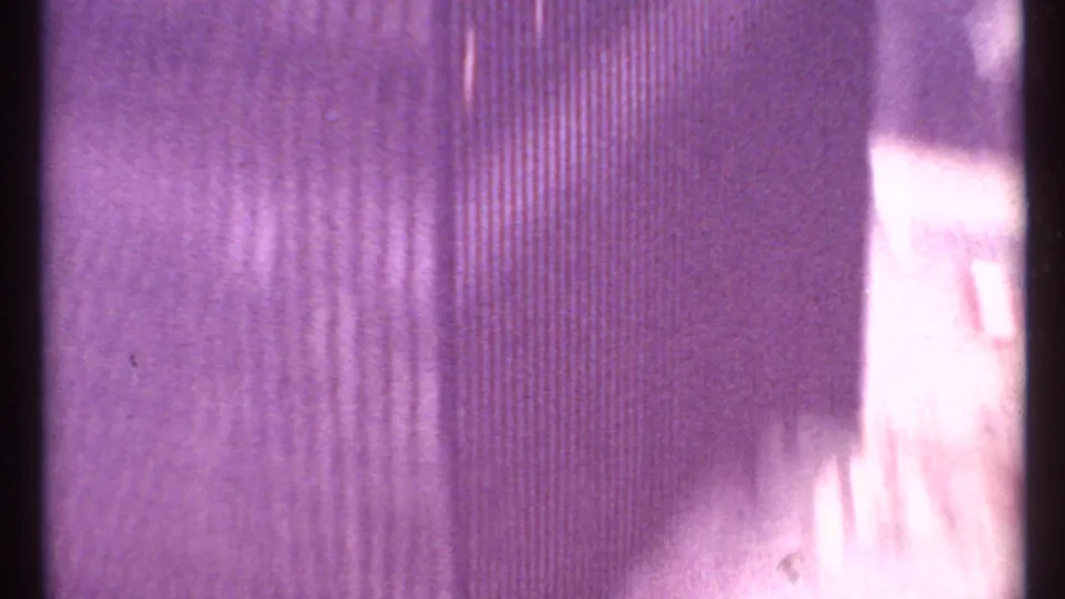 1967 8mm Toronto clip opening with a soft abstract passage of film grain, vertical streaks, and a pale overexposed band.
