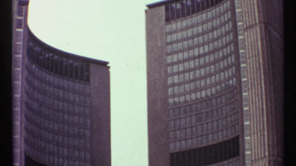 1967 Toronto 8mm view of modernist curved towers, emphasizing glass window grids and vertical concrete forms.