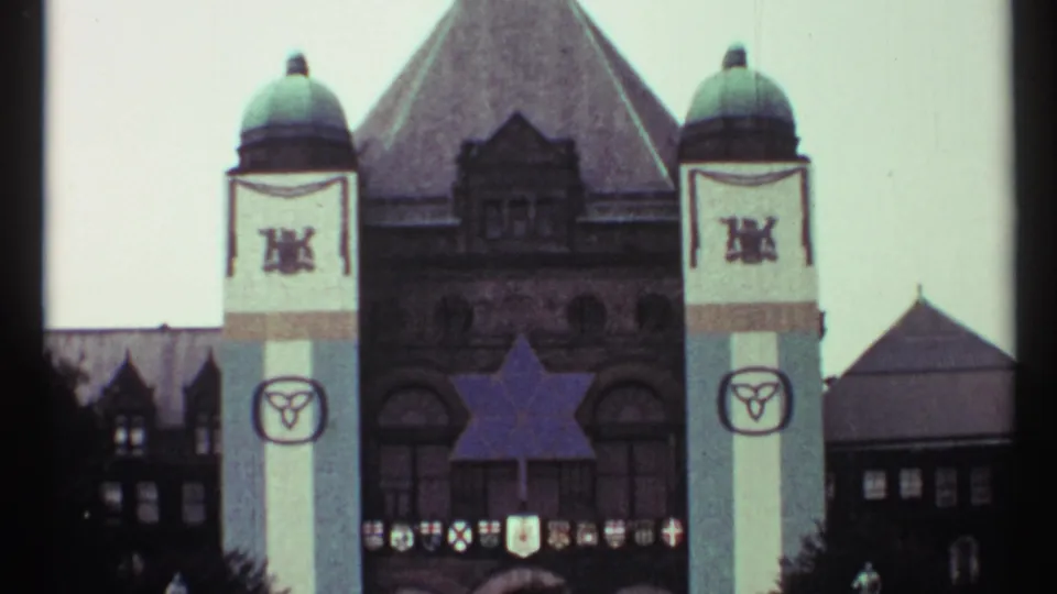 Toronto Old City Hall in 1967, framed from below with green domes, banners, a Star of David, and distant people near the building.