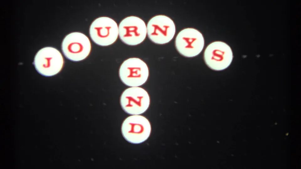 1967 Toronto 8mm frame showing the JOURNEYS END tile sign slightly left of center with visible film grain.