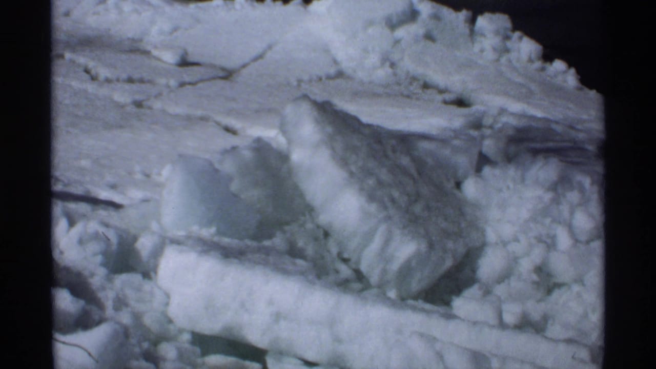 Close view of packed snow and broken ice chunks in a winter roadside pile.