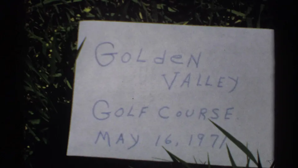 Handwritten location card on grass identifying Golden Valley Golf Course and the date May 16, 1971.