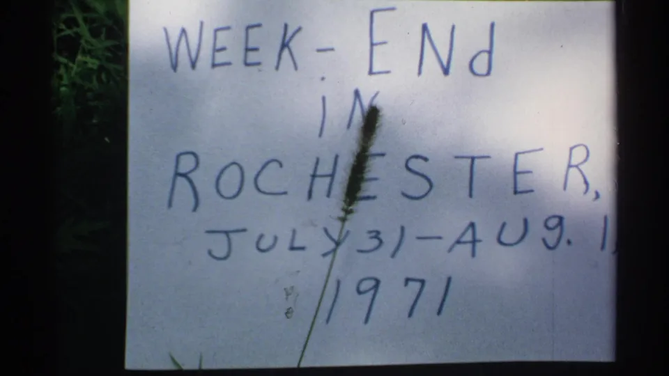 Handwritten home-movie title card references a weekend in Rochester and dates July 31-August 1, 1971, with grass partly crossing the frame.