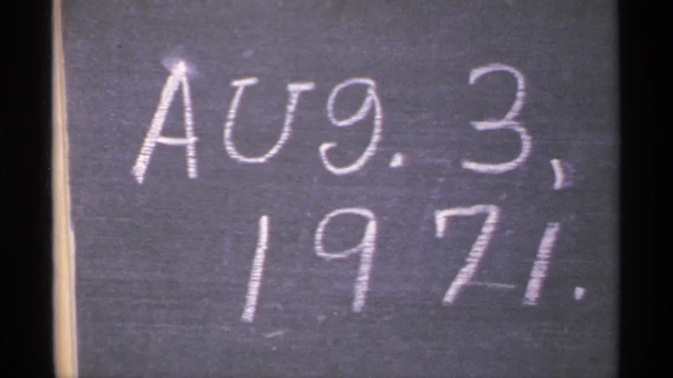 Close-up of a chalkboard date reading Aug. 3, 1970, used as an in-camera home-movie date card.
