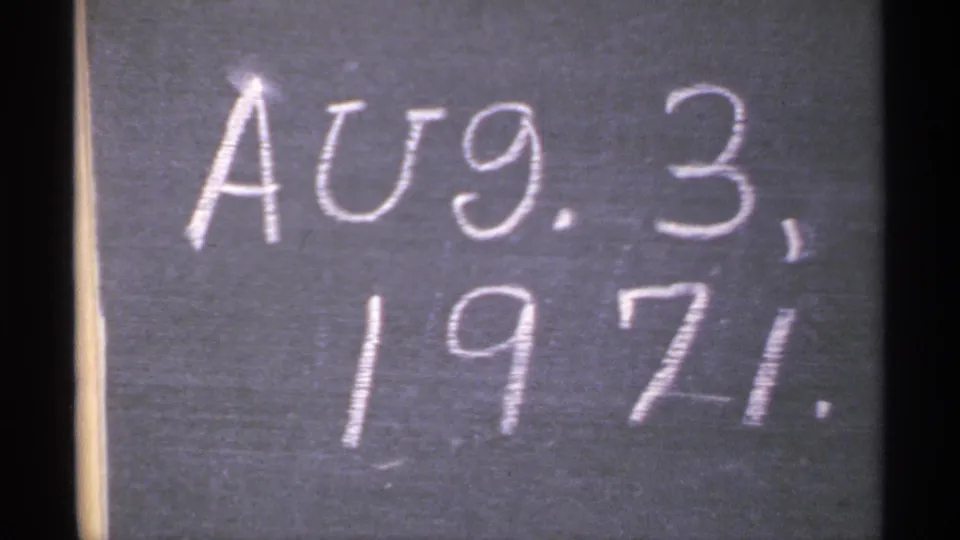 Close view of a chalkboard date reading Aug. 3, 1971 in a Minnesota home-movie clip.