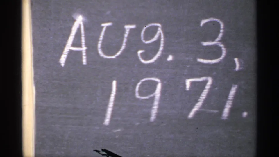 Another close frame of the handwritten Aug. 3, 1971 chalkboard date on 8mm film.