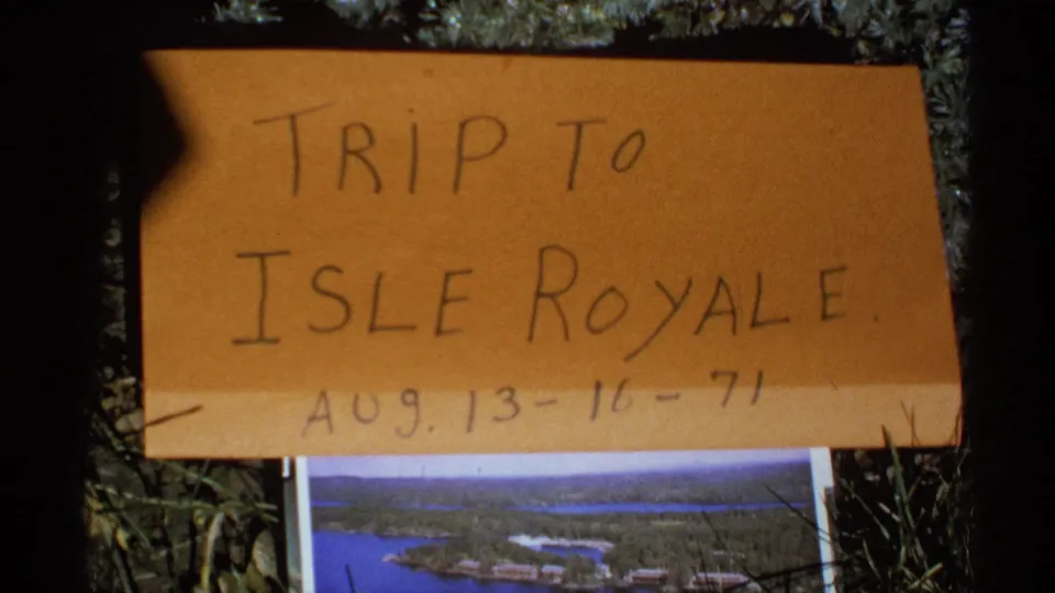 Handmade Isle Royale trip title card dated Aug. 13-16-71, filmed on 8mm with the lower edge of a park photograph visible beneath it.