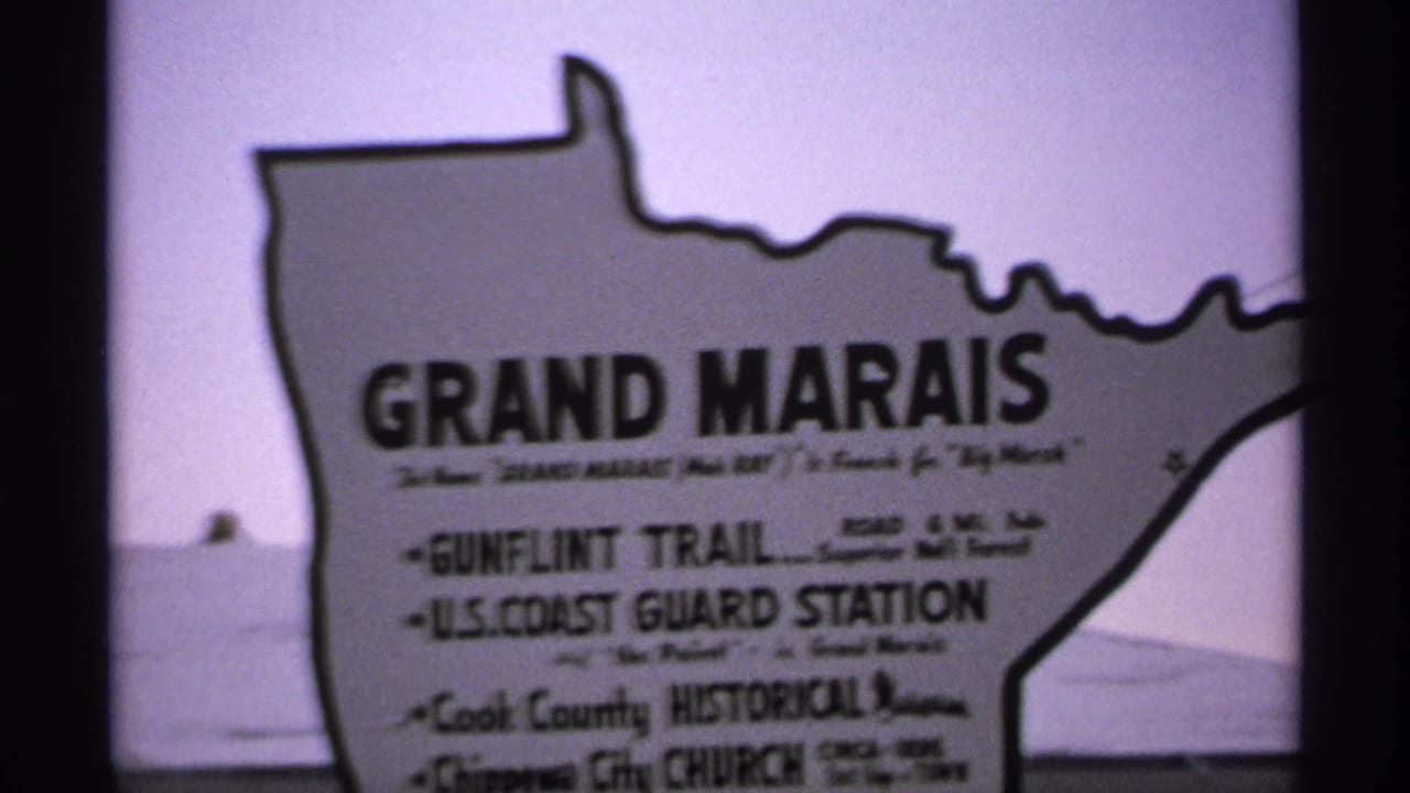 Grand Marais sign seen against a pale lakeside background.